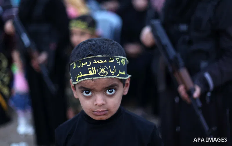 A Palestinian boy looks poses for a photograph during a ceremony organised by slamic Jihad movement in solidarity with Jerusalem and against the recent visits by Jewish activists to al-Aqsa mosque, in Gaza city November...