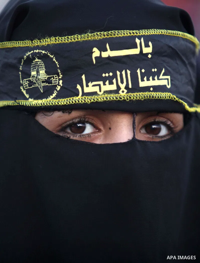 A Palestinian veiled woman who support Islamic Jihad movement attends a ceremony in solidarity with Jerusalem and against the recent visits by Jewish activists to al-Aqsa mosque, in Gaza city November 7, 2014. In recent...