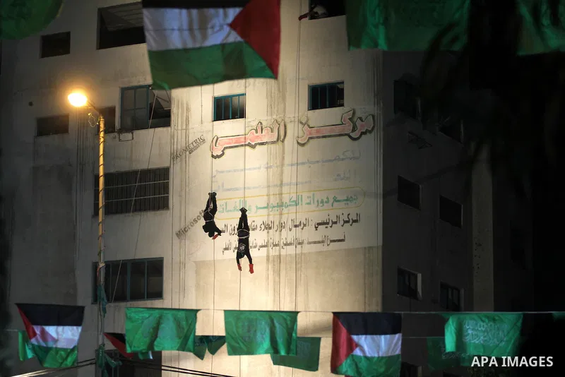 Palestinian members of Ezzedeen al-Qassam, the armed wing of Hamas movement, show their skills during a memorial service for the Palestinians who were killed during the seven-week Israeli offensive, in Gaza city November...