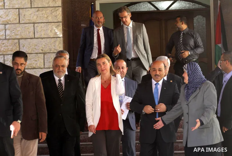European Union foreign policy chief Federica Mogherini , stands with the Minister of the Palestinian government in front of the headquarters of the prime minister in Gaza City November 8, 2014. Photo by Mohammed Asad