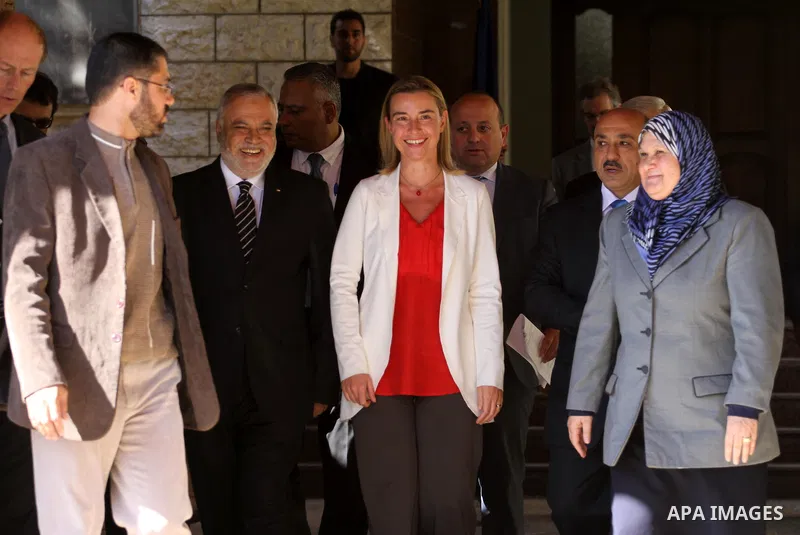 European Union foreign policy chief Federica Mogherini , stands with the Minister of the Palestinian government in front of the headquarters of the prime minister in Gaza City November 8, 2014. Photo by Mohammed Asad