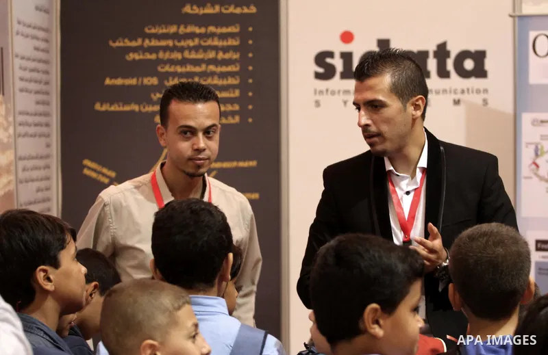 Palestinians attend Expotech IT exhibition, in Gaza city on November 11, 2014. Expotech is an annual exhibition that expose the potential of ICT Sector in Palestine to global industries trends and provide new information...