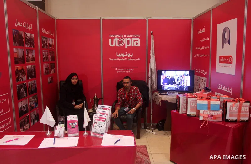 Palestinians attend Expotech IT exhibition, in Gaza city on November 11, 2014. Expotech is an annual exhibition that expose the potential of ICT Sector in Palestine to global industries trends and provide new information...