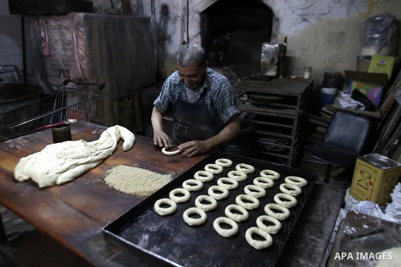 Palestinian baker Darwish Abu Samra, 77, bakes a traditional cake called 'Shami' at his old bakery in the old city of Nablus, West Bank, 02 November 2014. Abu Samra said his family started in this bakery in 1936 and sinc...