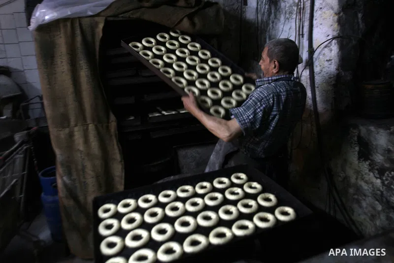 Palestinian baker Darwish Abu Samra, 77, bakes a traditional cake called 'Shami' at his old bakery in the old city of Nablus, West Bank, 02 November 2014. Abu Samra said his family started in this bakery in 1936 and sinc...