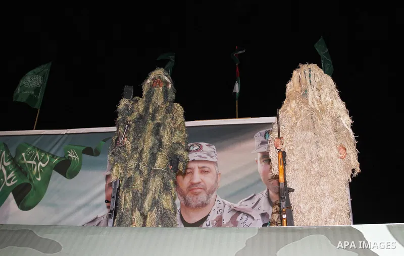 Palestinian members from the armed wing of Hamas take part in an anti-Israel rally in Rafah in the southern Gaza Strip on November 13, 2014. The rally was organized in memory of Hamas's military commanders who were kille...