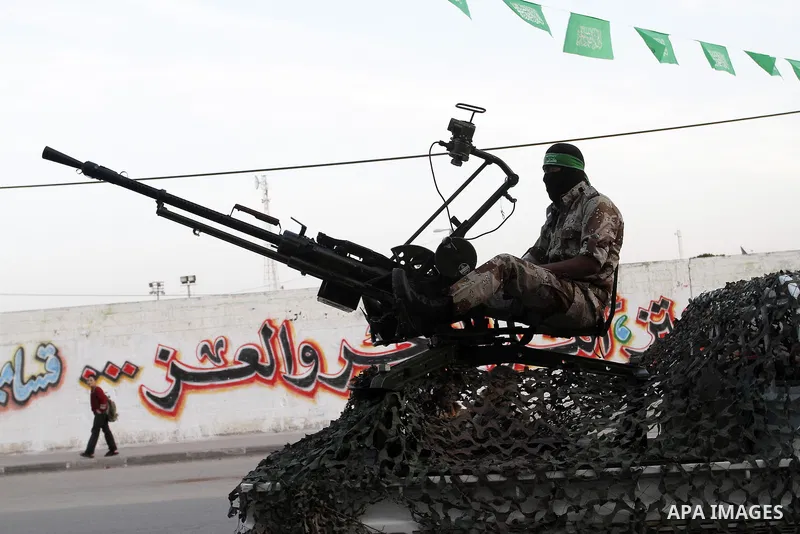 A Palestinian member of Hamas's armed wing sits on a military vehicle during an anti-Israel rally in Rafah in the southern Gaza Strip November 13, 2014. The rally was organized in memory of Hamas's military commanders wh...