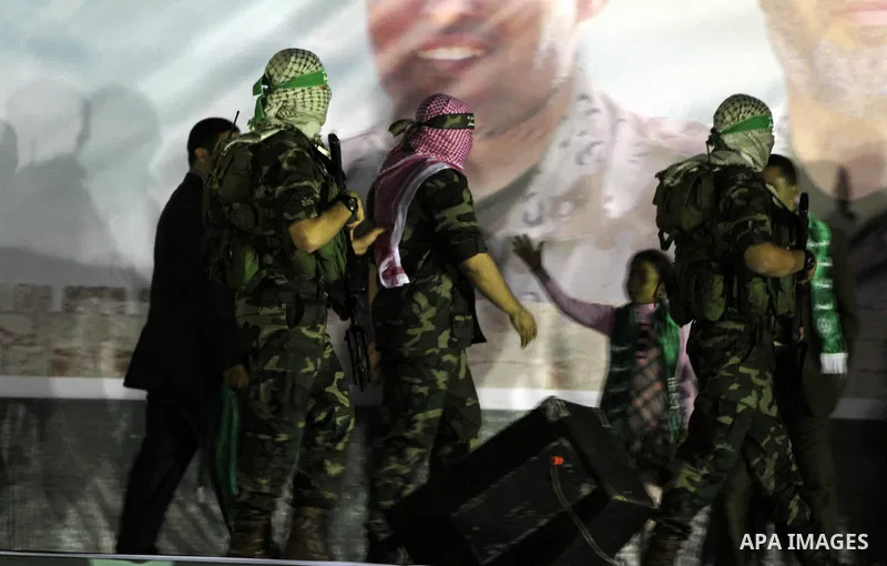 Palestinian members from the armed wing of Hamas take part in an anti-Israel rally in Rafah in the southern Gaza Strip on November 13, 2014. The rally was organized in memory of Hamas's military commanders who were kille...