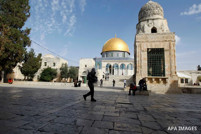 Palestinian worshippers walk outside the Dome of the Rock at the Al-Aqsa mosque compound after Friday prayers in the Old City of Jerusalem on November 14, 2014. Israel eased restrictions at Jerusalem's Al-Aqsa mosque aft...