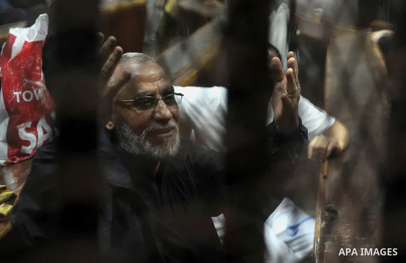 Muslim Brotherhood members sit inside the defendant's cage during their trial in cooperation cause in Cairo on Nov. 15, 2014. Morsi is being tried at a courtroom in the Police Academy in New Cairo along with 14 others on...