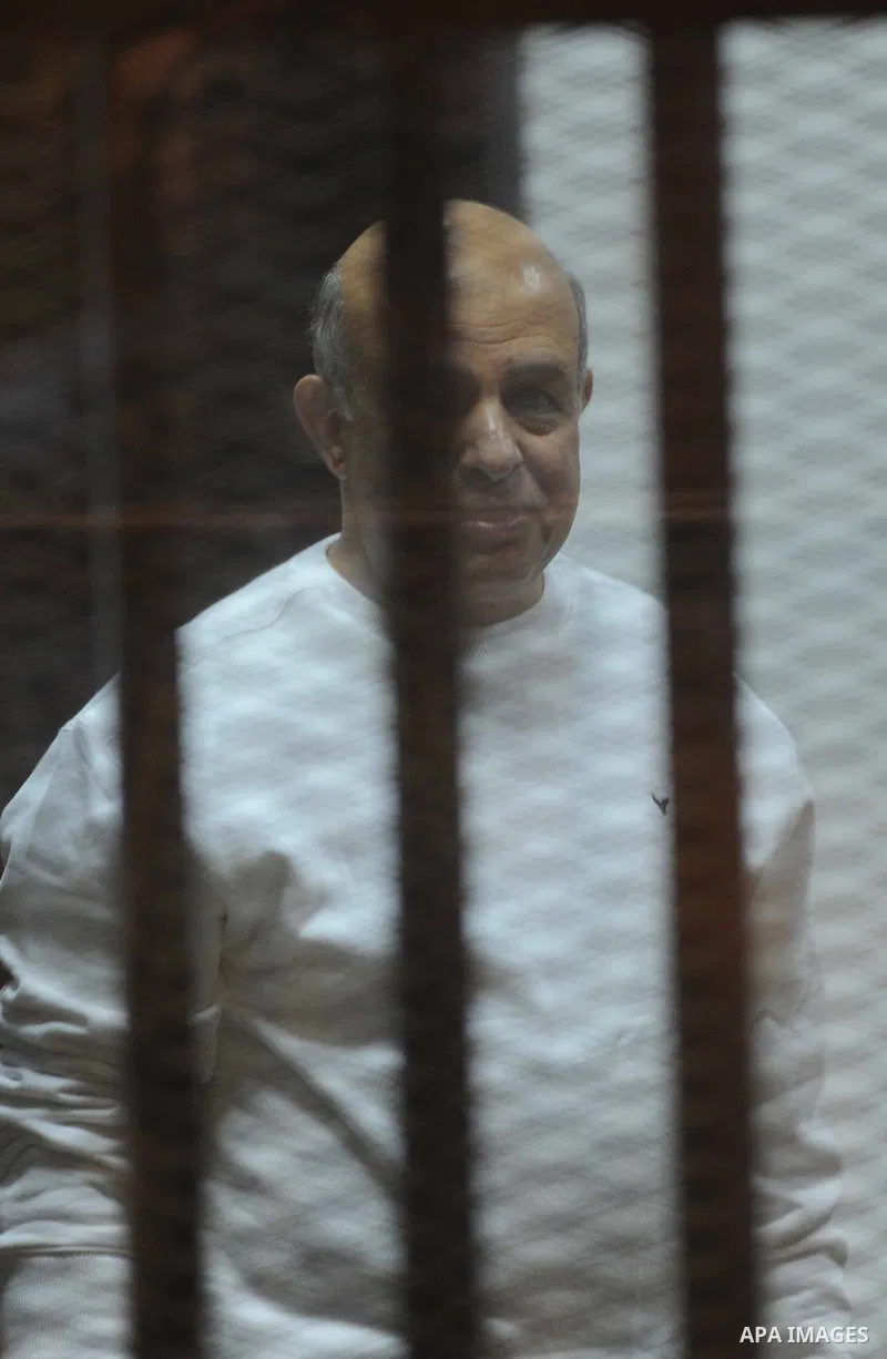 Muslim Brotherhood members sit inside the defendant's cage during their trial in cooperation cause in Cairo on Nov. 15, 2014. Morsi is being tried at a courtroom in the Police Academy in New Cairo along with 14 others on...
