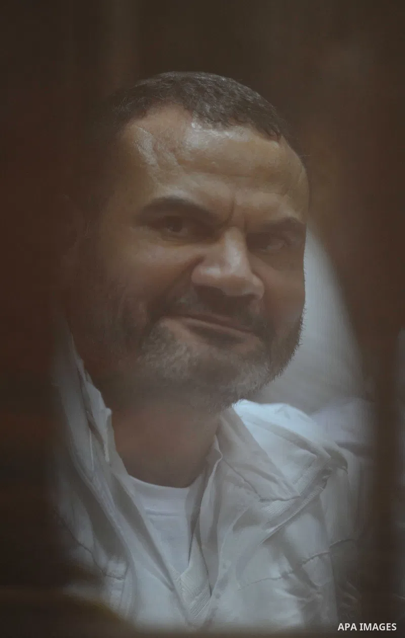 Muslim Brotherhood members sit inside the defendant's cage during their trial in cooperation cause in Cairo on Nov. 15, 2014. Morsi is being tried at a courtroom in the Police Academy in New Cairo along with 14 others on...