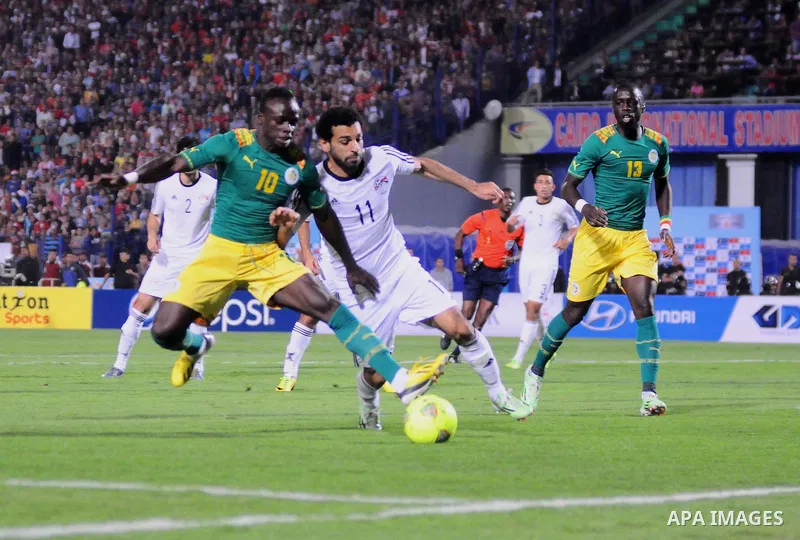 Egyptian players compete against with Senegal s players during their qualifying match of 2015 Africa Cup of Nations in Cairo, Egypt, on Nov. 15, 2014. Senegal won the match by 1-0. Photo by Amr Sayed