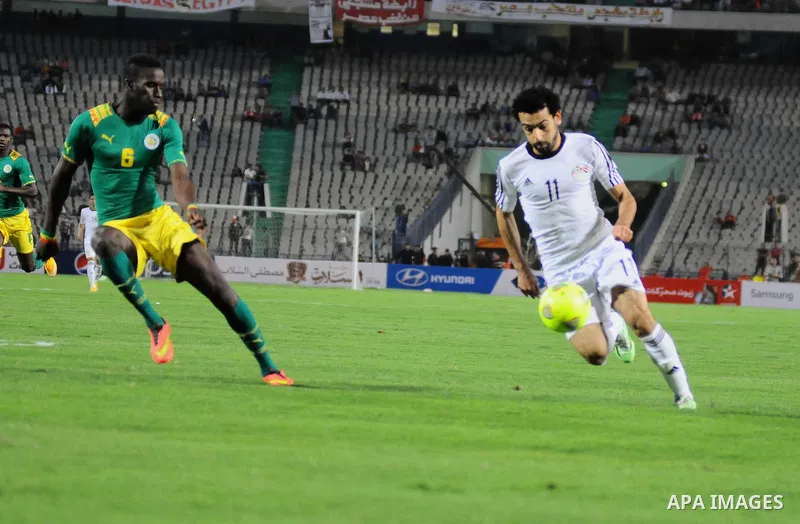 Egyptian players compete against with Senegal s players during their qualifying match of 2015 Africa Cup of Nations in Cairo, Egypt, on Nov. 15, 2014. Senegal won the match by 1-0. Photo by Amr Sayed