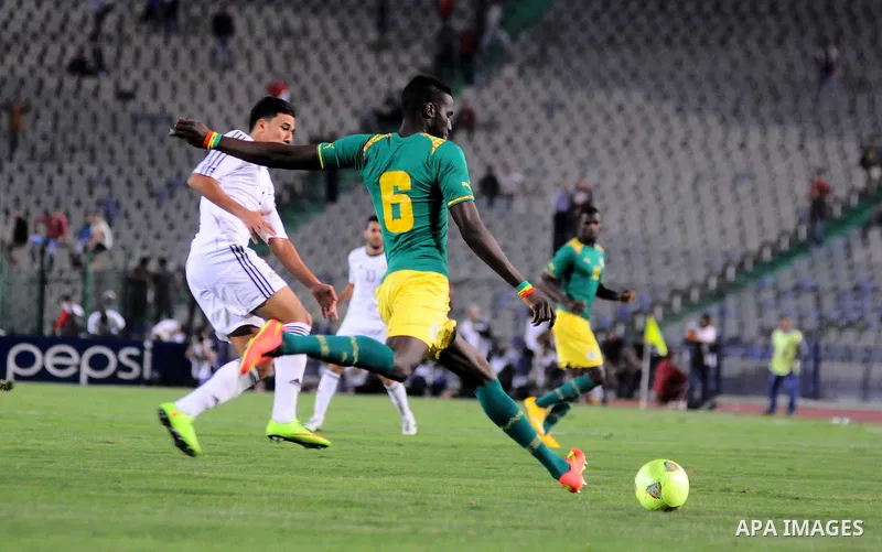 Egyptian players compete against with Senegal s players during their qualifying match of 2015 Africa Cup of Nations in Cairo, Egypt, on Nov. 15, 2014. Senegal won the match by 1-0. Photo by Amr Sayed