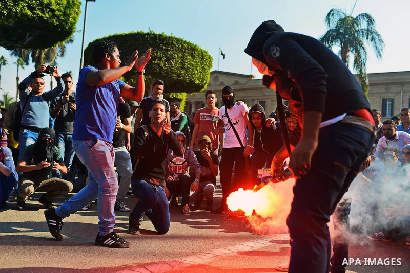 Egyptian students who support Muslim Brotherhood and ousted president Mohammed Morsi, take part in a demonstration to mark the World Student Day', in Cairo on November 17, 2014. The Students Against The Coup (SAC) moveme...