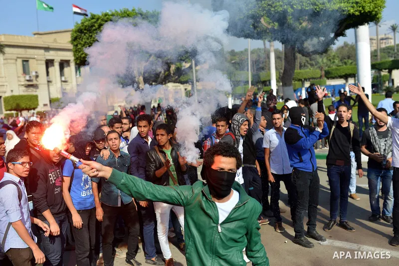 Egyptian students who support Muslim Brotherhood and ousted president Mohammed Morsi, take part in a demonstration to mark the World Student Day', in Cairo on November 17, 2014. The Students Against The Coup (SAC) moveme...