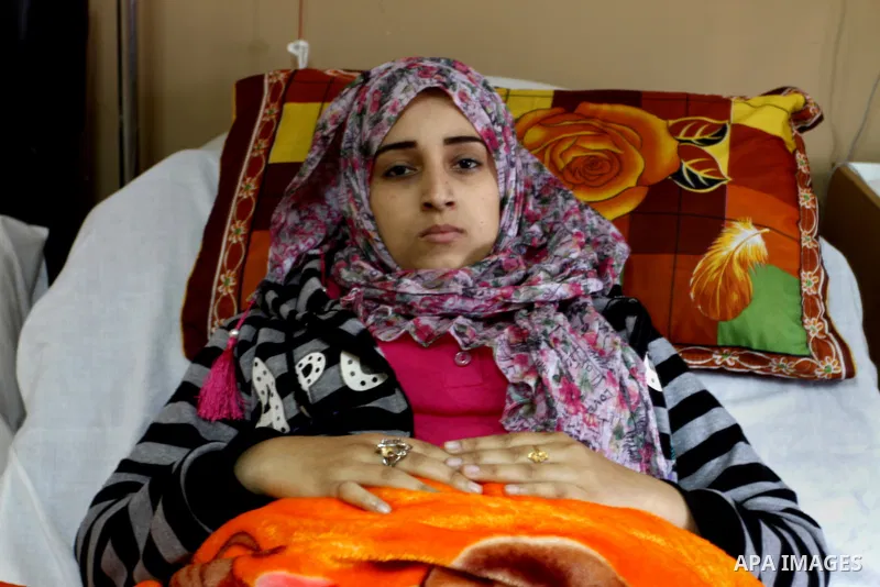 Nedaa Abu Daqqa, 20, a wounded Palestinian girl lays at a hospital bed as she wait to receive therapy treatment, at a hospital in Khan Younis, in the southern Gaza Strip, November 17, 2014. Abu Daqqa suffers from hemiple...