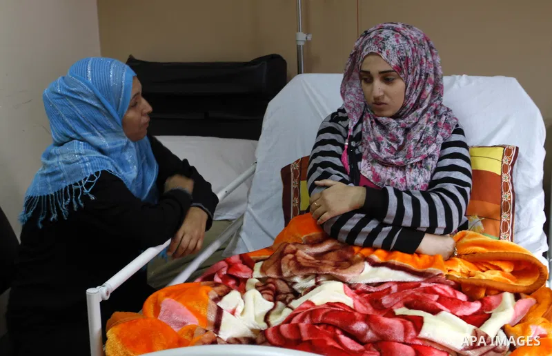 Nedaa Abu Daqqa, 20, a wounded Palestinian girl lays at a hospital bed as she wait to receive therapy treatment, at a hospital in Khan Younis, in the southern Gaza Strip, November 17, 2014. Abu Daqqa suffers from hemiple...
