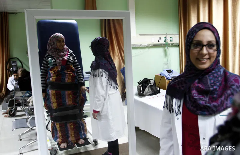 Nedaa Abu Daqqa, 20, a wounded Palestinian girl receives therapy treatment, at a hospital in Khan Younis, in the southern Gaza Strip, November 17, 2014. Abu Daqqa suffers from hemiplegia after she was injured in spine du...