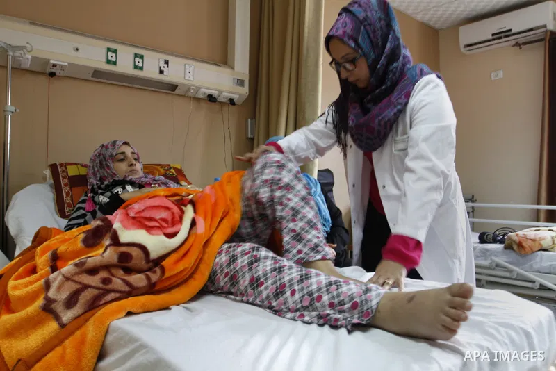 Nedaa Abu Daqqa, 20, a wounded Palestinian girl receives therapy treatment, at a hospital in Khan Younis, in the southern Gaza Strip, November 17, 2014. Abu Daqqa suffers from hemiplegia after she was injured in spine du...