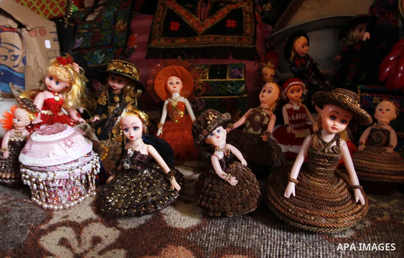 Handmade dolls, made by 38 year-old Palestinian, Nesreen Abu Louz, are displayed at her home in Khan Younis, in the southern Gaza Strip, November 19, 2014. Abu Louz make different toys of dolls and cardboard models from...