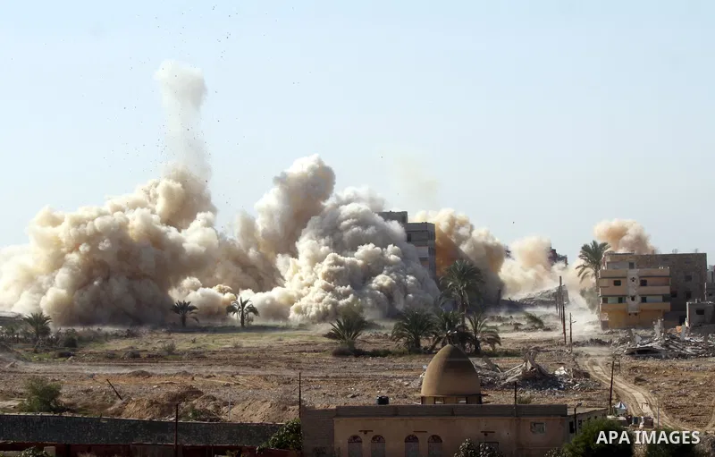 Smoke rises after a house was blown up during a military operation by Egyptian security forces in the Egyptian city of Rafah near the border with southern Gaza Strip on November 20, 2014. Egypt is set to expand the buffe...