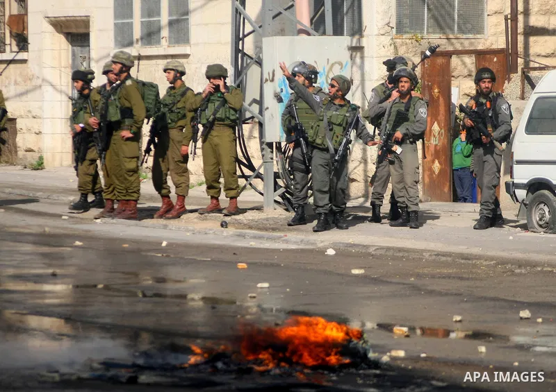 Israeli security forces take position during clashes with Palestinian protesters following a protest against the recent Israeli measures in Jerusalem, in the West Bank city of Hebron, November 21, 2014. Israel eased age...
