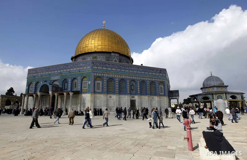 Palestinian worshippers take part in Friday prayers outside the Dome of the Rock at the Al-Aqsa mosque compound in the Old City of Jerusalem on November 21, 2014. Israel eased age restrictions for Friday prayers at Jerus...