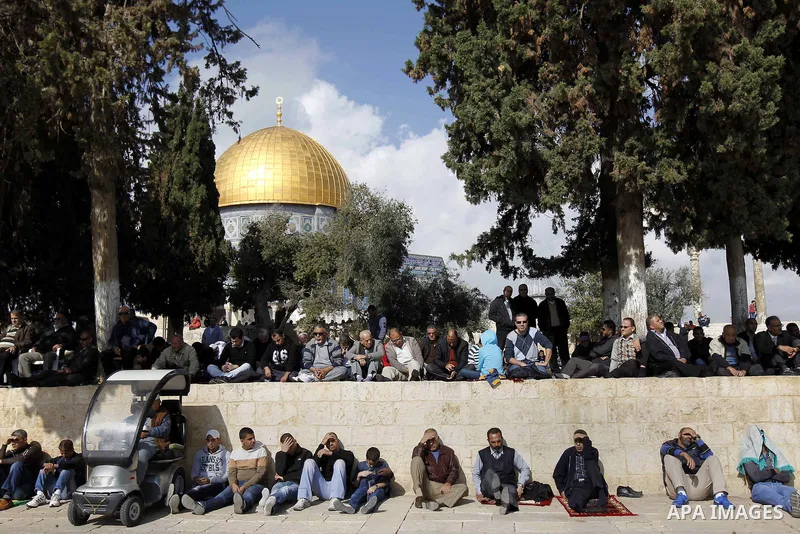 Palestinian worshippers take part in Friday prayers outside the Dome of the Rock at the Al-Aqsa mosque compound in the Old City of Jerusalem on November 21, 2014. Israel eased age restrictions for Friday prayers at Jerus...