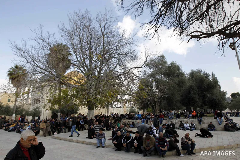 Palestinian worshippers take part in Friday prayers outside the Dome of the Rock at the Al-Aqsa mosque compound in the Old City of Jerusalem on November 21, 2014. Israel eased age restrictions for Friday prayers at Jerus...