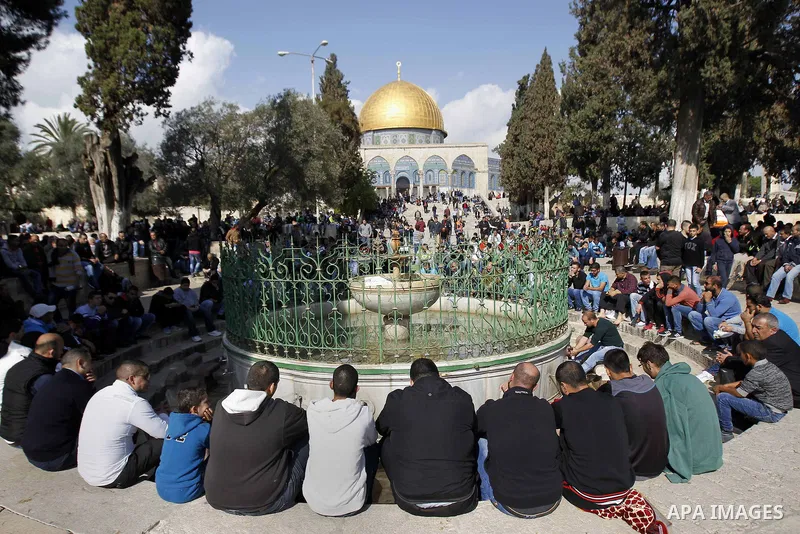 Palestinian worshippers take part in Friday prayers outside the Dome of the Rock at the Al-Aqsa mosque compound in the Old City of Jerusalem on November 21, 2014. Israel eased age restrictions for Friday prayers at Jerus...