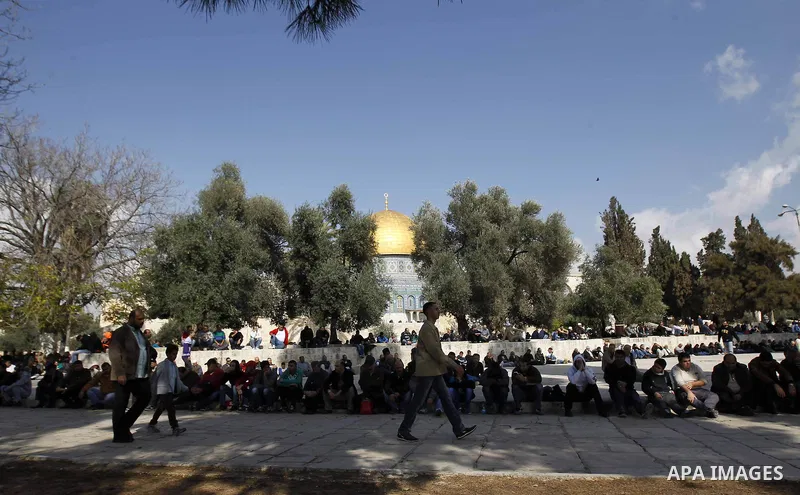 Palestinian worshippers take part in Friday prayers outside the Dome of the Rock at the Al-Aqsa mosque compound in the Old City of Jerusalem on November 21, 2014. Israel eased age restrictions for Friday prayers at Jerus...