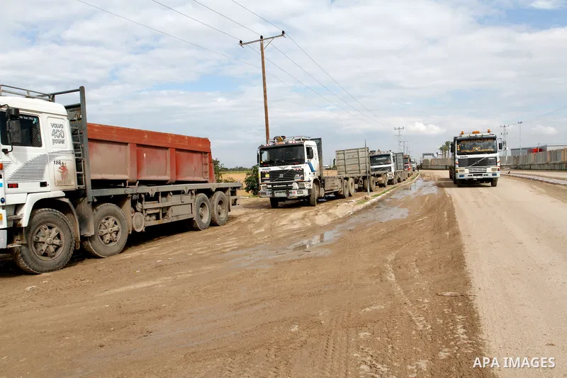 Trucks loaded with cement enter the Gaza Strip from Israel through the Kerem Shalom crossing in Rafah in the southern Gaza Strip on November 25, 2014. Twenty-eight trucks of cement entered the battered Gaza Strip Tuesday...