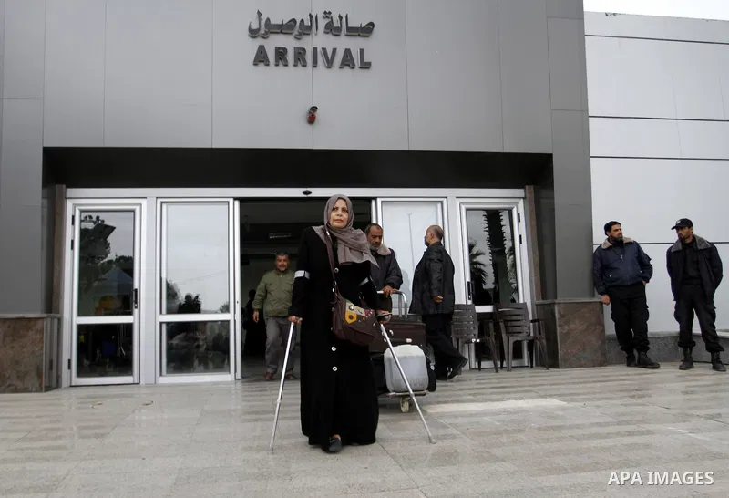 Palestinians returning to Gaza arrive at the Rafah border crossing between Egypt and southern Gaza Strip November 26, 2014. Egypt reopened the Rafah crossing with Gaza, which is the only access point to the Palestinian t...