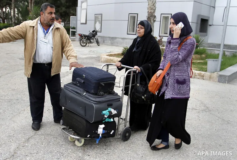 Palestinians returning to Gaza arrive at the Rafah border crossing between Egypt and southern Gaza Strip November 26, 2014. Egypt reopened the Rafah crossing with Gaza, which is the only access point to the Palestinian t...