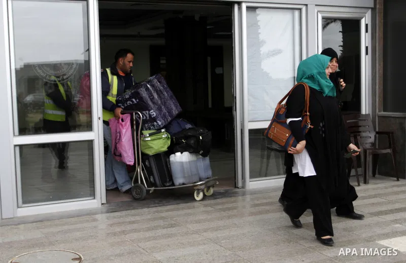Palestinians returning to Gaza arrive at the Rafah border crossing between Egypt and southern Gaza Strip November 26, 2014. Egypt reopened the Rafah crossing with Gaza, which is the only access point to the Palestinian t...