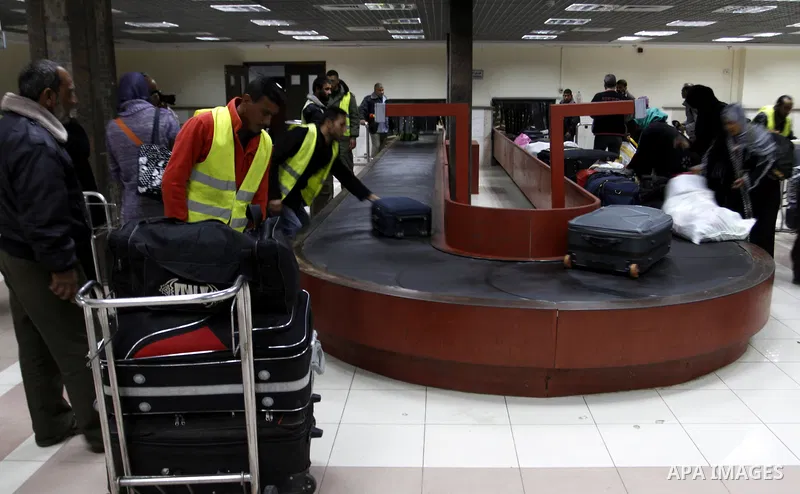 Palestinians returning to Gaza arrive at the Rafah border crossing between Egypt and southern Gaza Strip November 26, 2014. Egypt reopened the Rafah crossing with Gaza, which is the only access point to the Palestinian t...