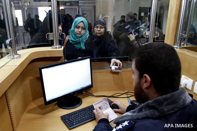 Palestinians returning to Gaza wait to stamp their passports at the Rafah border crossing between Egypt and southern Gaza Strip on November 26, 2014. Egypt reopened the Rafah crossing with Gaza, which is the only access...