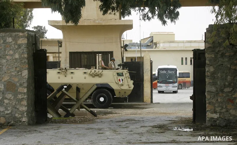 An Egyptian soldier stands guard, as Palestinians returning to Gaza, arrive at the Rafah border crossing between Egypt and southern Gaza Strip November 26, 2014. Egypt reopened the Rafah crossing with Gaza, which is the...