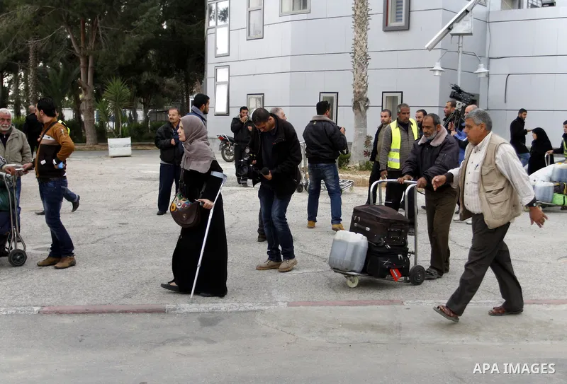 Palestinians returning to Gaza arrive at the Rafah border crossing between Egypt and southern Gaza Strip November 26, 2014. Egypt reopened the Rafah crossing with Gaza, which is the only access point to the Palestinian t...