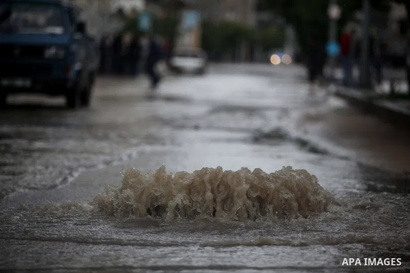 Palestinians make their way through a flooded street during heavy rains in Gaza City on November 27, 2014 as a fierce winter storm which has been battering the region for the past four days. Photo by Ashraf Amra