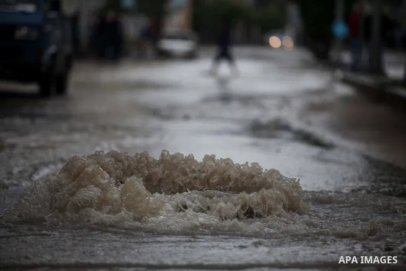 Palestinians make their way through a flooded street during heavy rains in Gaza City on November 27, 2014 as a fierce winter storm which has been battering the region for the past four days. Photo by Ashraf Amra