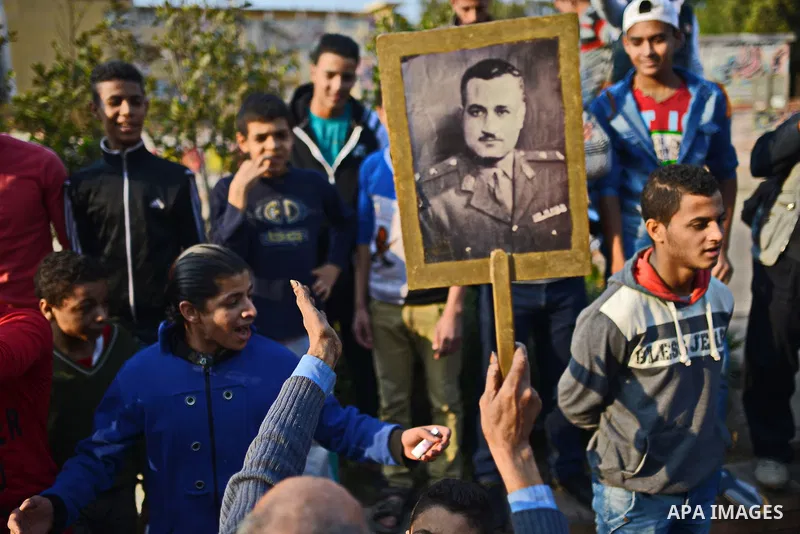 An Egyptian man holds a picture of former Egyptian leader Jamal Abdel Nasser during a rally to support the President Abdel Fattah al-Sisi, in Cairo on November 28, 2014. The planned Islamist protests that have been calle...