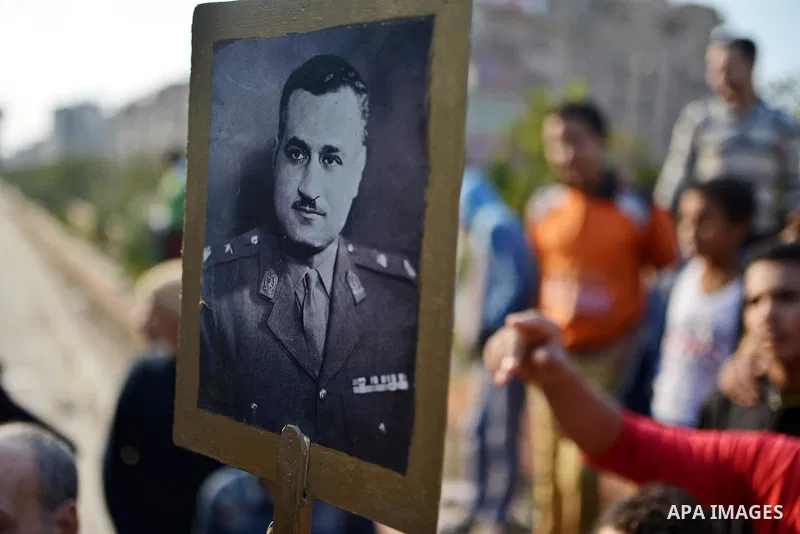 An Egyptian man holds a picture of former Egyptian leader Jamal Abdel Nasser during a rally to support the President Abdel Fattah al-Sisi, in Cairo on November 28, 2014. The planned Islamist protests that have been calle...