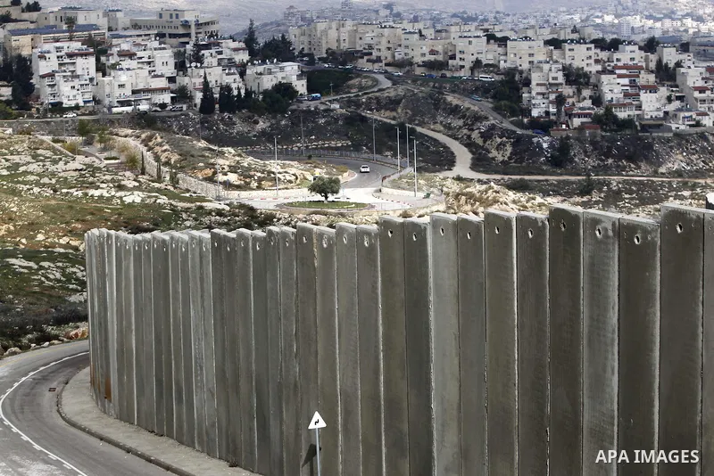 A general view shows the Palestinian Shuafat refugee camp behind Israel s controversial separation barrier in east Jerusalem on November 28, 2014. Israel has introduced a series of measures against the families of Palest...