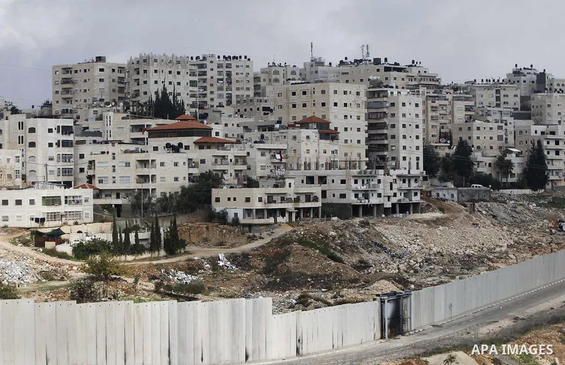 A general view shows the Palestinian Shuafat refugee camp behind Israel s controversial separation barrier in east Jerusalem on November 28, 2014. Israel has introduced a series of measures against the families of Palest...