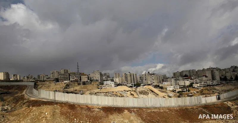 A general view shows the Palestinian Shuafat refugee camp behind Israel s controversial separation barrier in east Jerusalem on November 28, 2014. Israel has introduced a series of measures against the families of Palest...