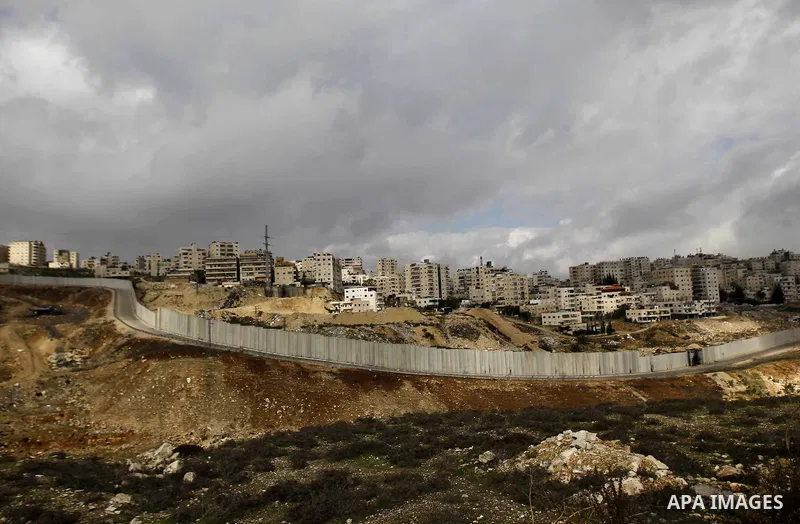 A general view shows the Palestinian Shuafat refugee camp behind Israel s controversial separation barrier in east Jerusalem on November 28, 2014. Israel has introduced a series of measures against the families of Palest...