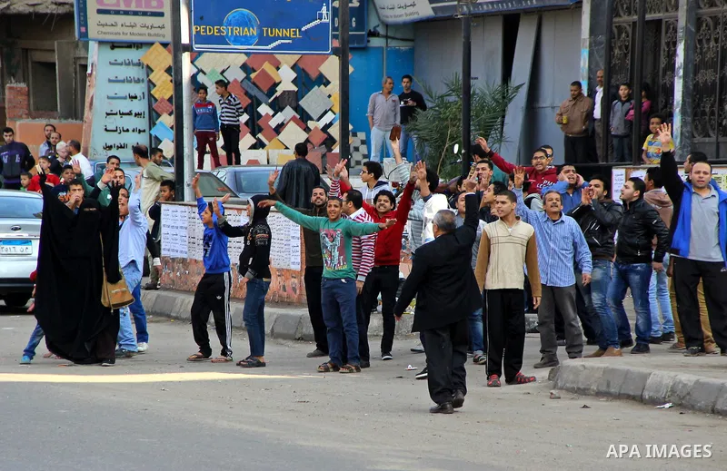 A small group of Egyptians hold up copies of the Koran and make the four fingered gesture associated with the clearing of a Muslim Brotherhood demonstration in the Rabaa Square which followed the ouster of Mohammed Morsi...
